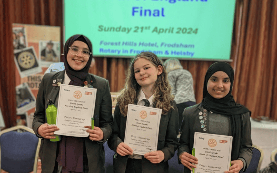Three students from Laurus Cheadle Hulme smile as they hold their certificates which they received as the Intermediate Runners Up of the Rotary Youth Speaks North of England Final 2024.